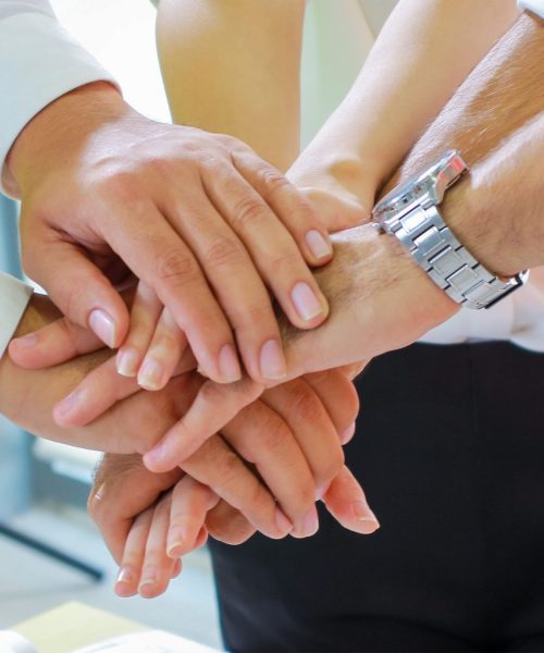 group of business people working in team ฺbrainstorming stacking hands together